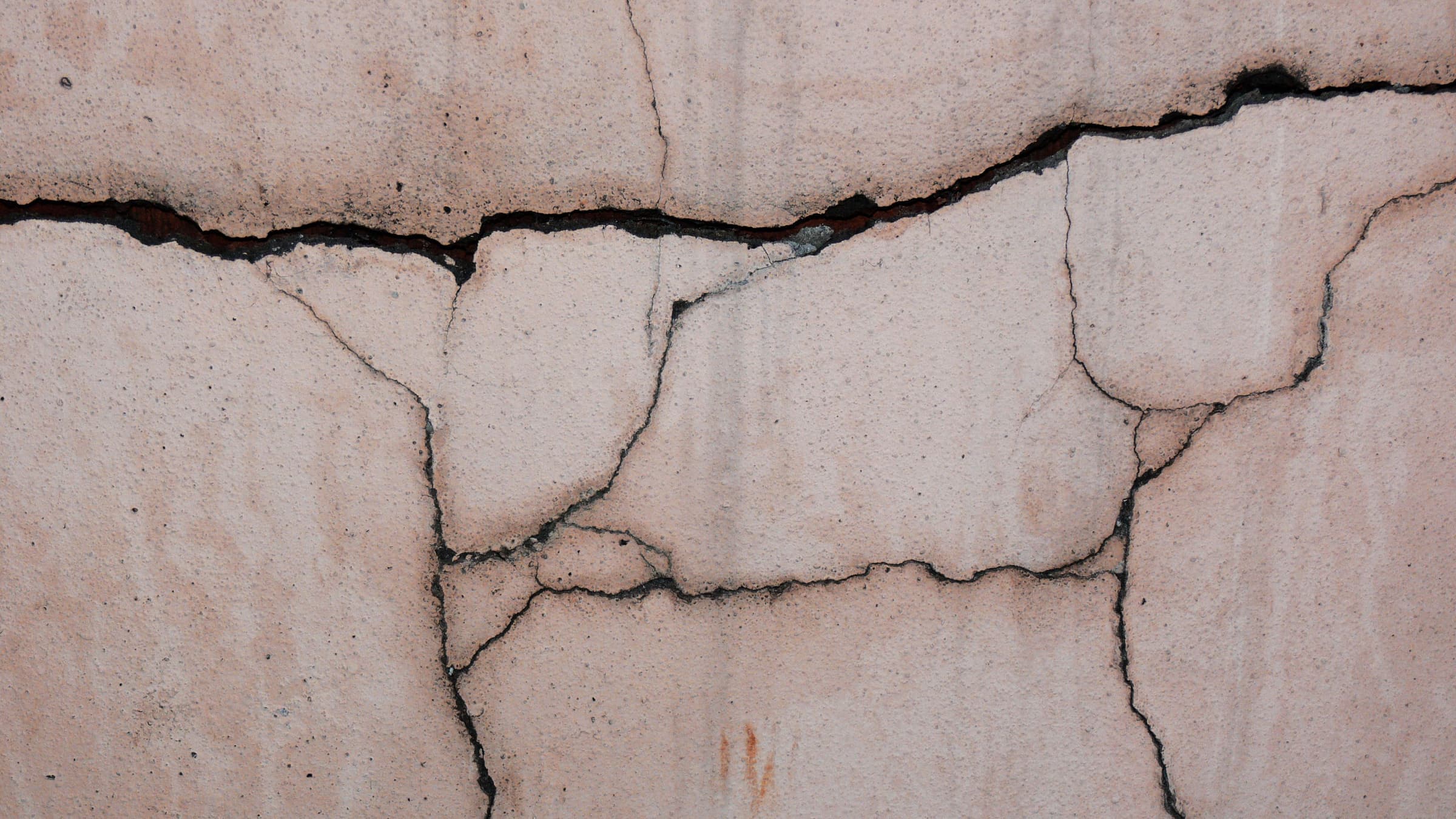 Structural cracks running across a concrete wall.